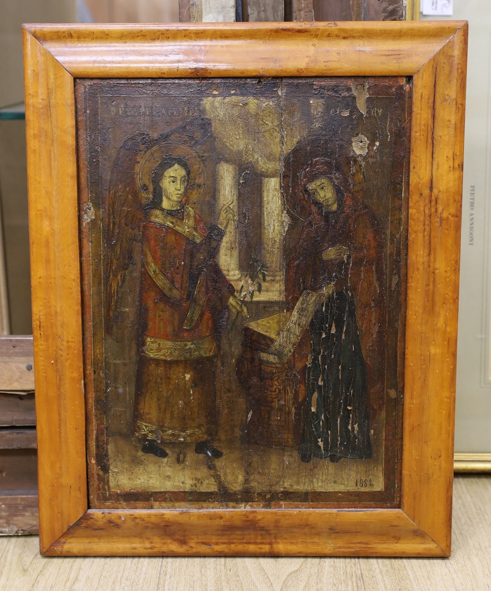 19th century Eastern European School, tempera on wooden panel, Icon depicting The Annunciation, inscribed and dated 1882, 38 x 28cm